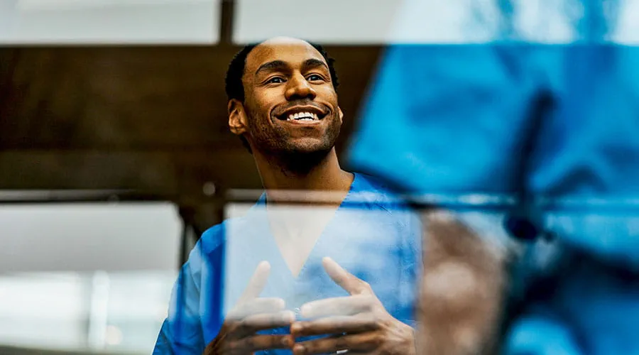  Doctor smiling in clinical environment
