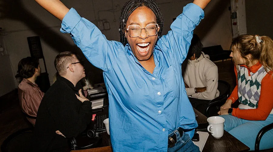  Person celebrating with raised arms in social setting