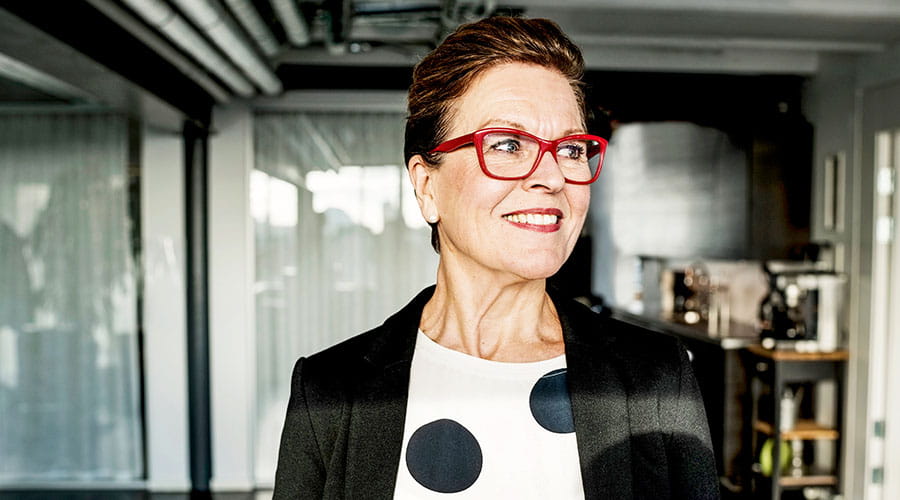 Professional standing in office wearing glasses Professional standing in office wearing glasses