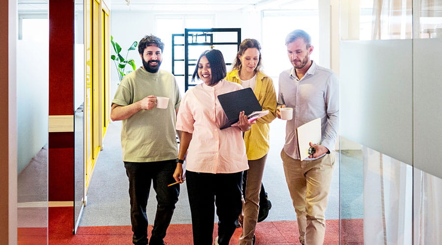  Team walking together in modern office space