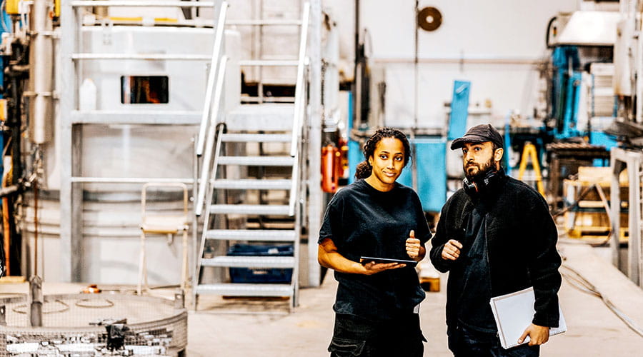  Two workers walking through industrial facility